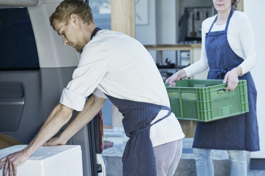 Replay Products | A man and woman loading eco-friendly packaging boxes into a van.